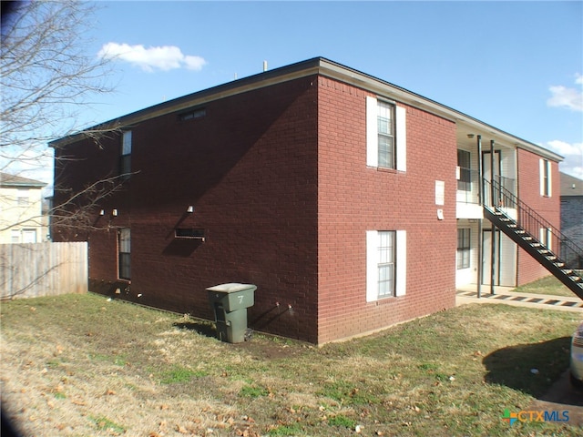 view of property exterior with a yard