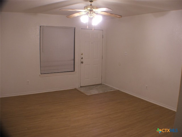 spare room with ceiling fan and wood-type flooring