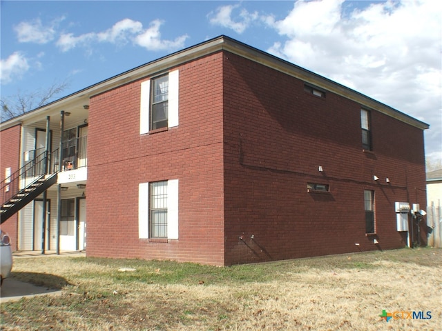 view of side of home featuring a lawn