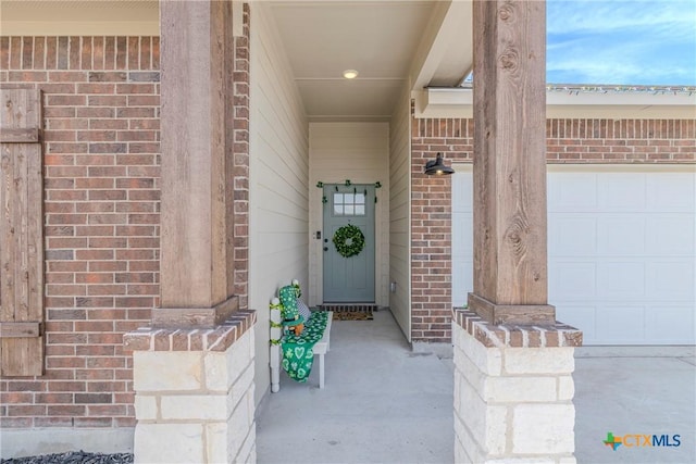 707 Winscott Ave, Temple, TX 76502 - doorway to property featuring brick siding and an attached garage