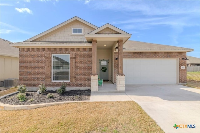 707 Winscott Ave, Temple, TX 76502 - view of front of house with brick siding, a garage, driveway, cooling unit, and a front lawn