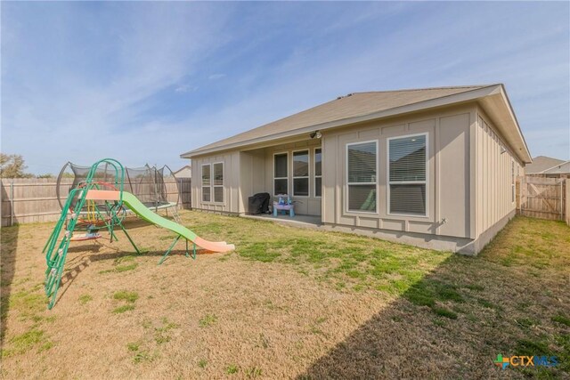 707 Winscott Ave, Temple, TX 76502 - rear view of house featuring a playground and board and batten siding