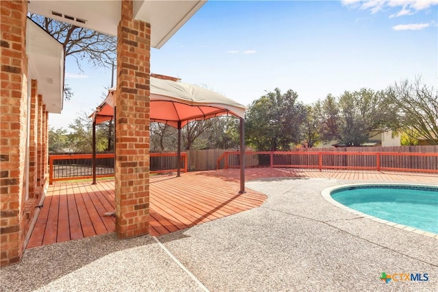 view of swimming pool featuring a fenced in pool, a fenced backyard, a gazebo, and a wooden deck