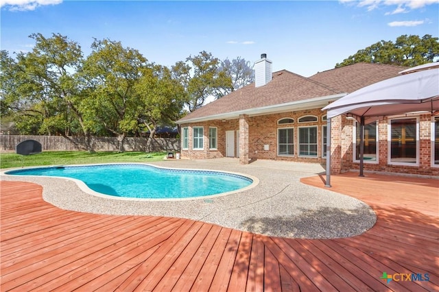 view of pool featuring a deck, a patio area, fence, and a fenced in pool