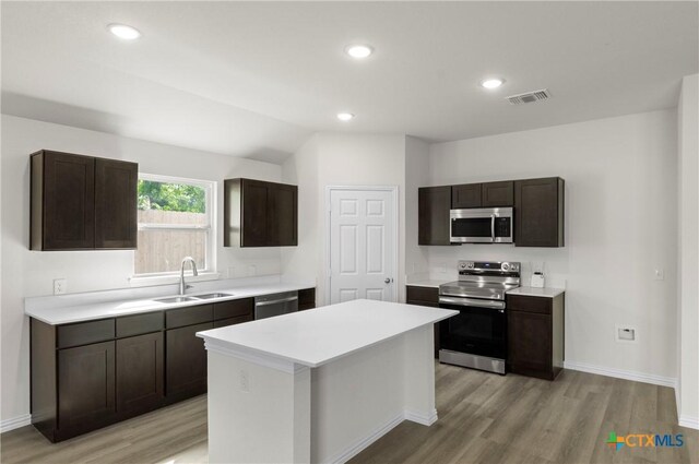 3812 Keller Rd, Temple, TX 76504 - kitchen with stainless steel appliances, light wood-style floors, light countertops, dark brown cabinets, and recessed lighting