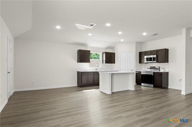 3812 Keller Rd, Temple, TX 76504 - kitchen with stainless steel appliances, open floor plan, light countertops, dark brown cabinetry, and recessed lighting