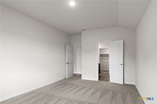 3812 Keller Rd, Temple, TX 76504 - unfurnished bedroom with carpet floors, a walk in closet, and lofted ceiling