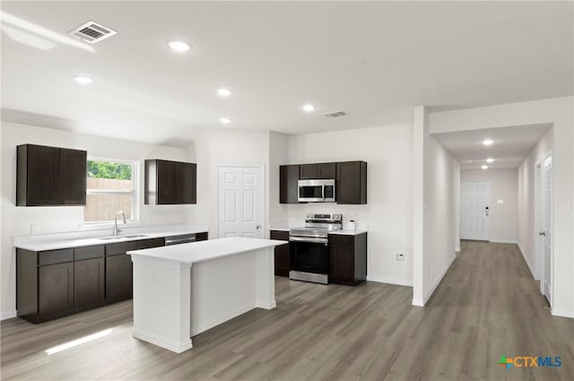3812 Keller Rd, Temple, TX 76504 - kitchen with stainless steel appliances, light countertops, light wood finished floors, a kitchen island, and recessed lighting