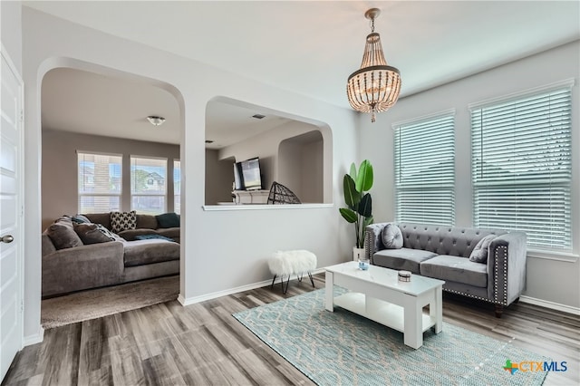 living room featuring a notable chandelier and hardwood / wood-style flooring