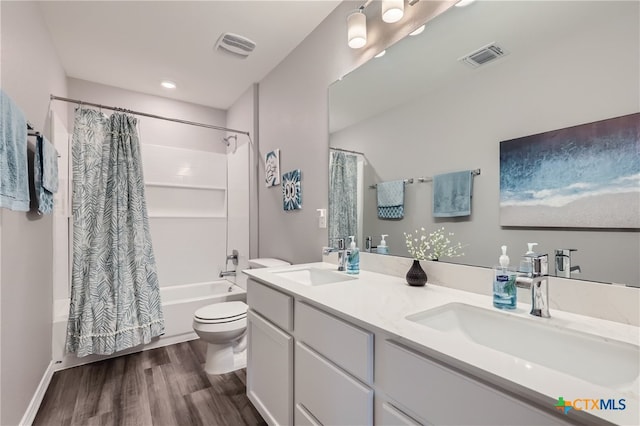 full bathroom featuring toilet, shower / bath combo with shower curtain, vanity, and hardwood / wood-style flooring