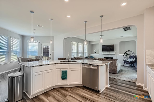 kitchen with a wealth of natural light, dishwasher, white cabinets, and sink