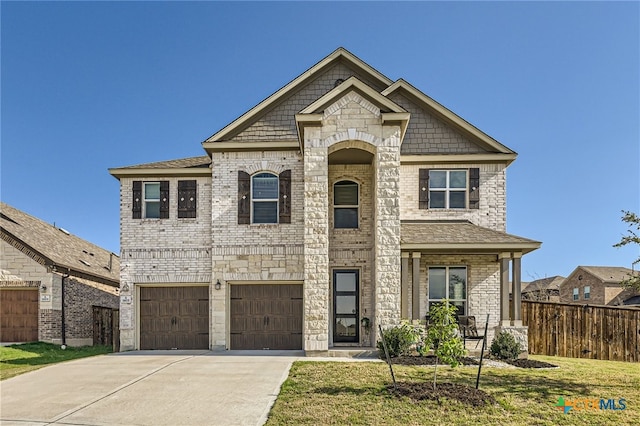 view of front of property featuring a garage and a front lawn