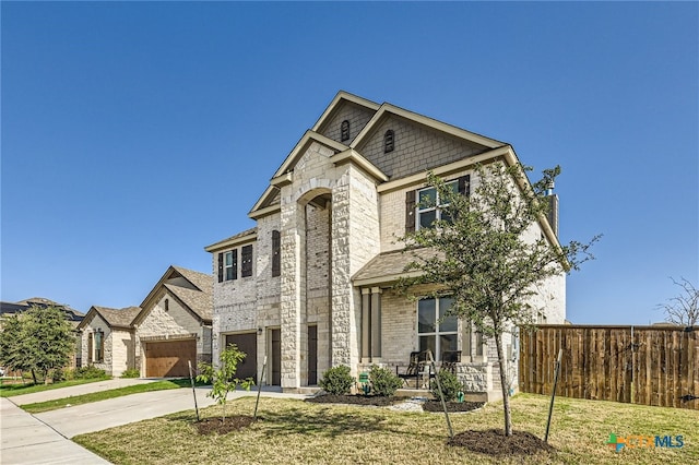 view of front facade featuring a garage and a front lawn