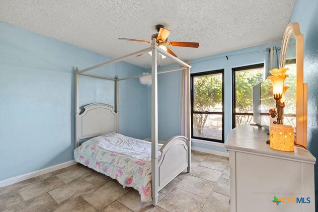 bathroom with curtained shower, ceiling fan, a textured ceiling, and toilet