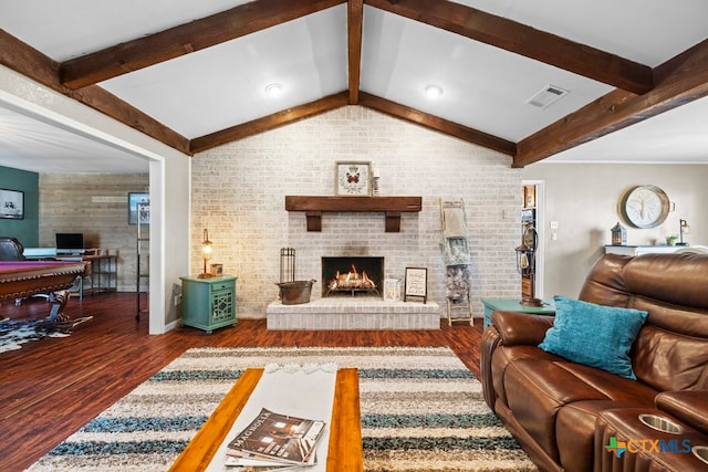 living room with a brick fireplace, vaulted ceiling with beams, pool table, dark hardwood / wood-style flooring, and brick wall