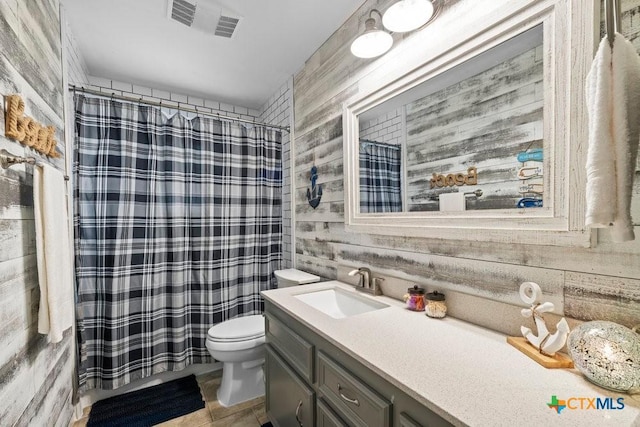 bathroom with shower / tub combo, visible vents, vanity, and toilet