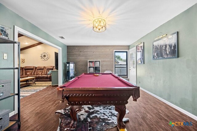 living room featuring hardwood / wood-style floors, lofted ceiling with beams, and an inviting chandelier