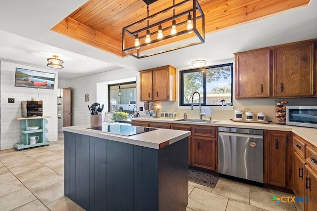 kitchen with wooden ceiling, a sink, appliances with stainless steel finishes, a wealth of natural light, and a tray ceiling