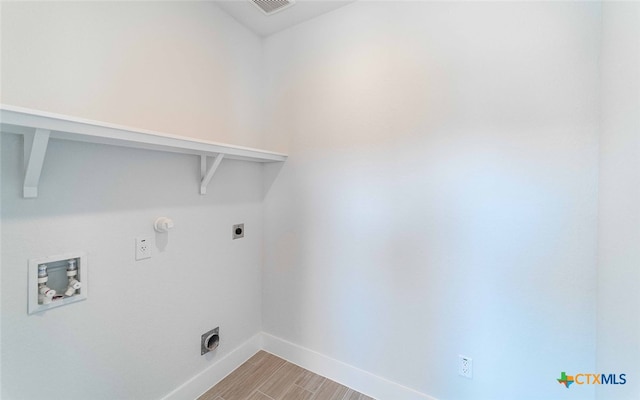 laundry area with hookup for an electric dryer, hookup for a washing machine, and light hardwood / wood-style flooring