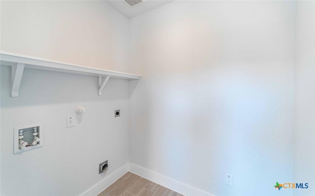 513 Lina Way, Seguin, TX 78155 - laundry area featuring hookup for an electric dryer, hookup for a washing machine, baseboards, and light wood-style floors