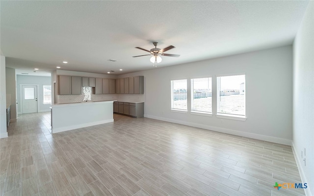 kitchen with ceiling fan, plenty of natural light, light hardwood / wood-style flooring, and a center island