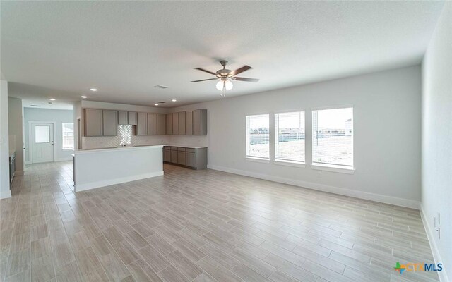 513 Lina Way, Seguin, TX 78155 - unfurnished living room featuring baseboards, ceiling fan, healthy amount of natural light, and recessed lighting