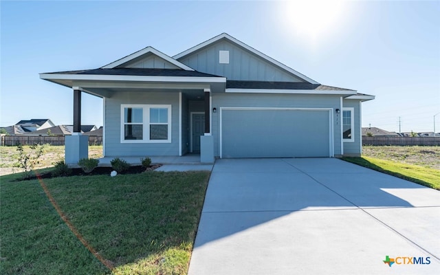 view of front of home featuring a garage and a front yard