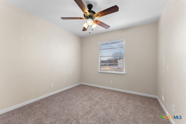 carpeted spare room featuring ceiling fan