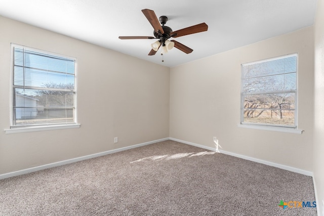 carpeted spare room with ceiling fan