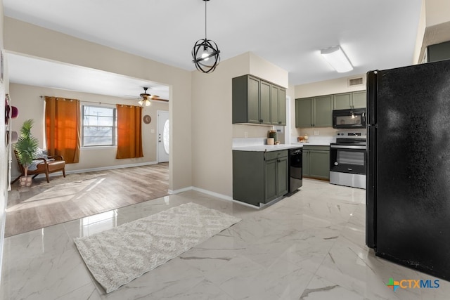 kitchen featuring ceiling fan, hanging light fixtures, green cabinets, and black appliances