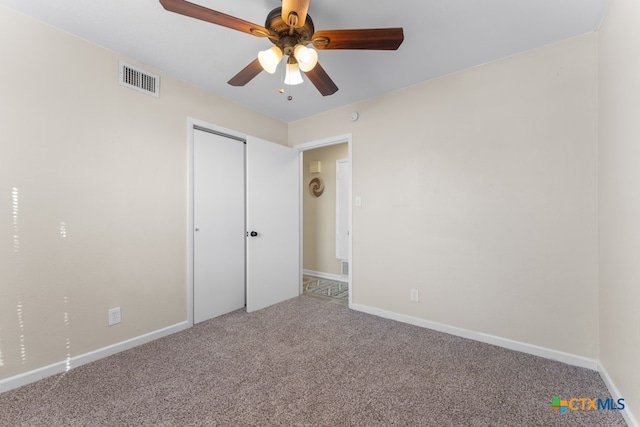 unfurnished bedroom with a closet, ceiling fan, and carpet floors