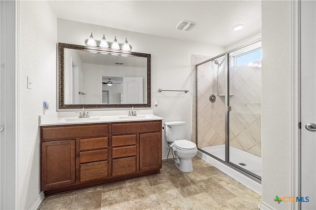 full bath with toilet, a sink, a shower stall, and visible vents