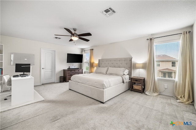 carpeted bedroom featuring visible vents, ceiling fan, and multiple windows