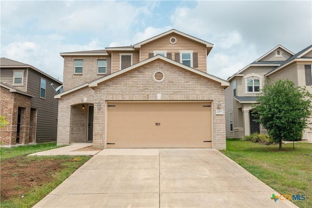 traditional-style home featuring a front yard, concrete driveway, a garage, and brick siding