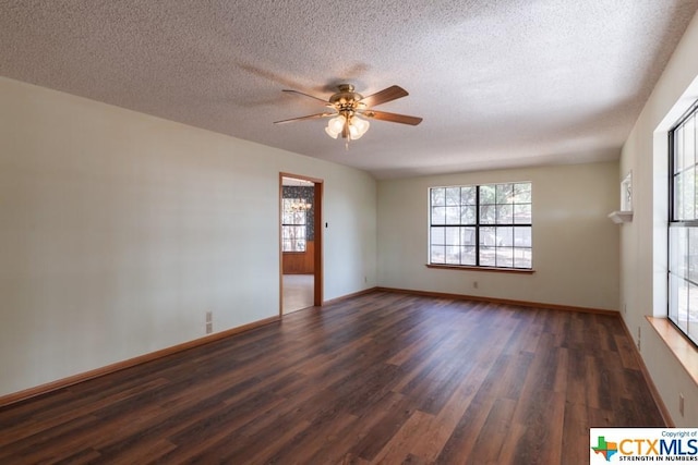 121 S Scenic Loop, Canyon Lake, TX 78133 - spare room featuring dark wood-style flooring, a ceiling fan, a textured ceiling, and baseboards
