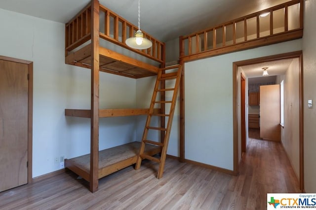 121 S Scenic Loop, Canyon Lake, TX 78133 - unfurnished bedroom with wood finished floors and baseboards