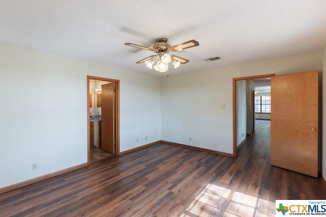 121 S Scenic Loop, Canyon Lake, TX 78133 - spare room featuring dark wood finished floors, a ceiling fan, and baseboards