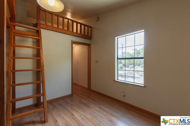 121 S Scenic Loop, Canyon Lake, TX 78133 - unfurnished bedroom with light wood finished floors and baseboards