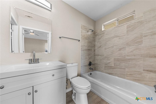 full bathroom featuring toilet, shower / tub combination, wood finished floors, and vanity