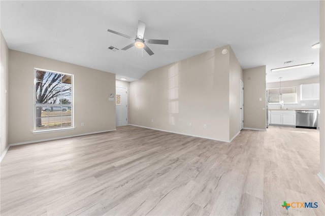 unfurnished living room with light wood finished floors, ceiling fan, visible vents, and baseboards