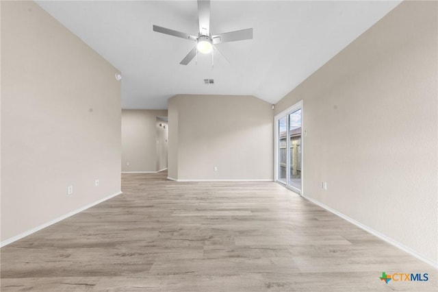 unfurnished room with visible vents, light wood-style flooring, a ceiling fan, vaulted ceiling, and baseboards