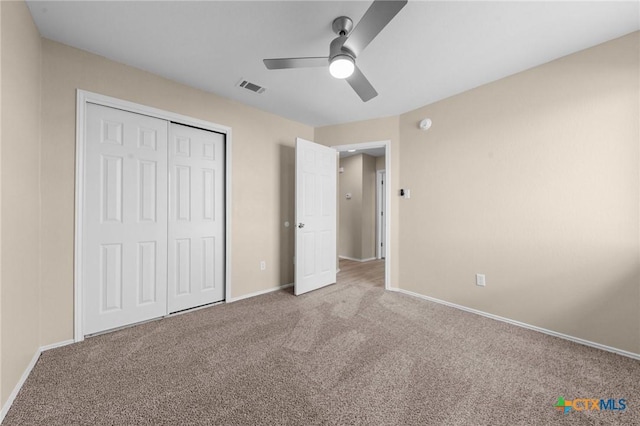 unfurnished bedroom featuring carpet floors, baseboards, and a closet