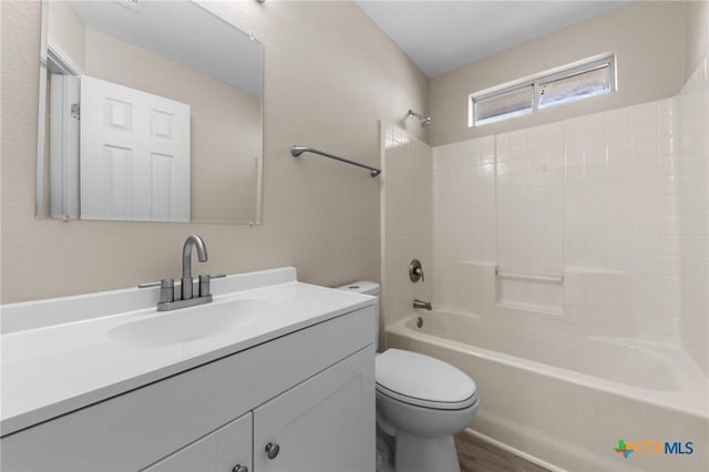 bathroom with toilet, shower / bathtub combination, and vanity