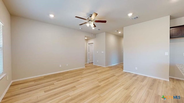 unfurnished room with ceiling fan and light wood-type flooring