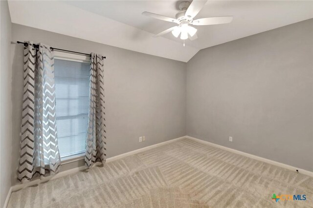 105 Legend Dr, Victoria, TX 77904 - spare room featuring ceiling fan, carpet, baseboards, and vaulted ceiling