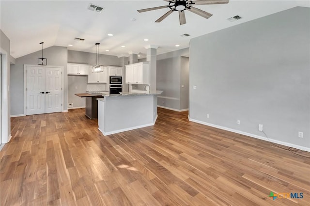 105 Legend Dr, Victoria, TX 77904 - kitchen with stainless steel appliances, ceiling fan, lofted ceiling, white cabinets, and light wood-type flooring