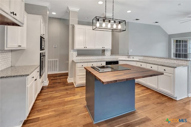 105 Legend Dr, Victoria, TX 77904 - kitchen with wooden counters, a peninsula, a sink, tasteful backsplash, and appliances with stainless steel finishes