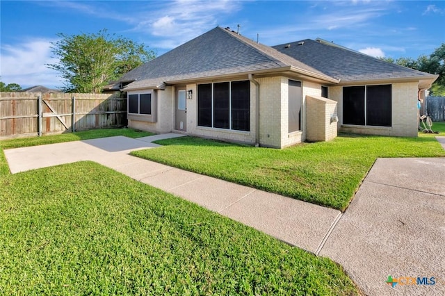 105 Legend Dr, Victoria, TX 77904 - back of property featuring a shingled roof and brick siding