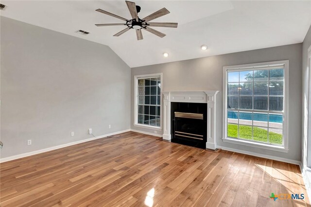 105 Legend Dr, Victoria, TX 77904 - unfurnished living room featuring lofted ceiling, ceiling fan, light wood-style flooring, baseboards, and a fireplace with flush hearth