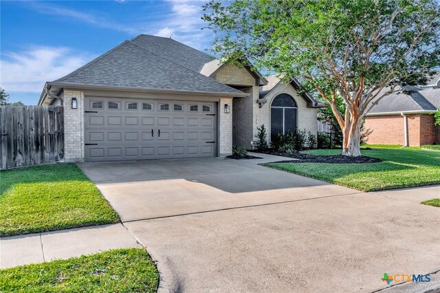105 Legend Dr, Victoria, TX 77904 - single story home featuring brick siding, roof with shingles, concrete driveway, and an attached garage